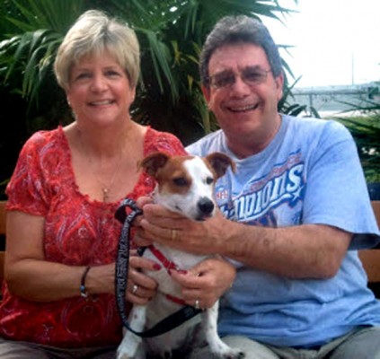 Penny and Carey Sackener, pose with Charlie, who they adopted during the “Get on Board” promotion in October.