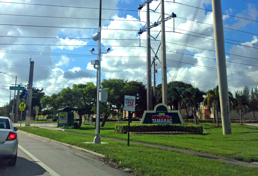 Scam Cam Tower proudly displayed next to the "Playful City USA" sign in Tamarac