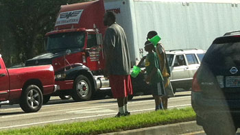 This family was panhandling on this major roadway. I was afraid for their safety.