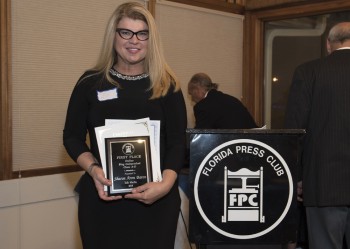 Sharon Aron Baron with award from the Florida Press Club