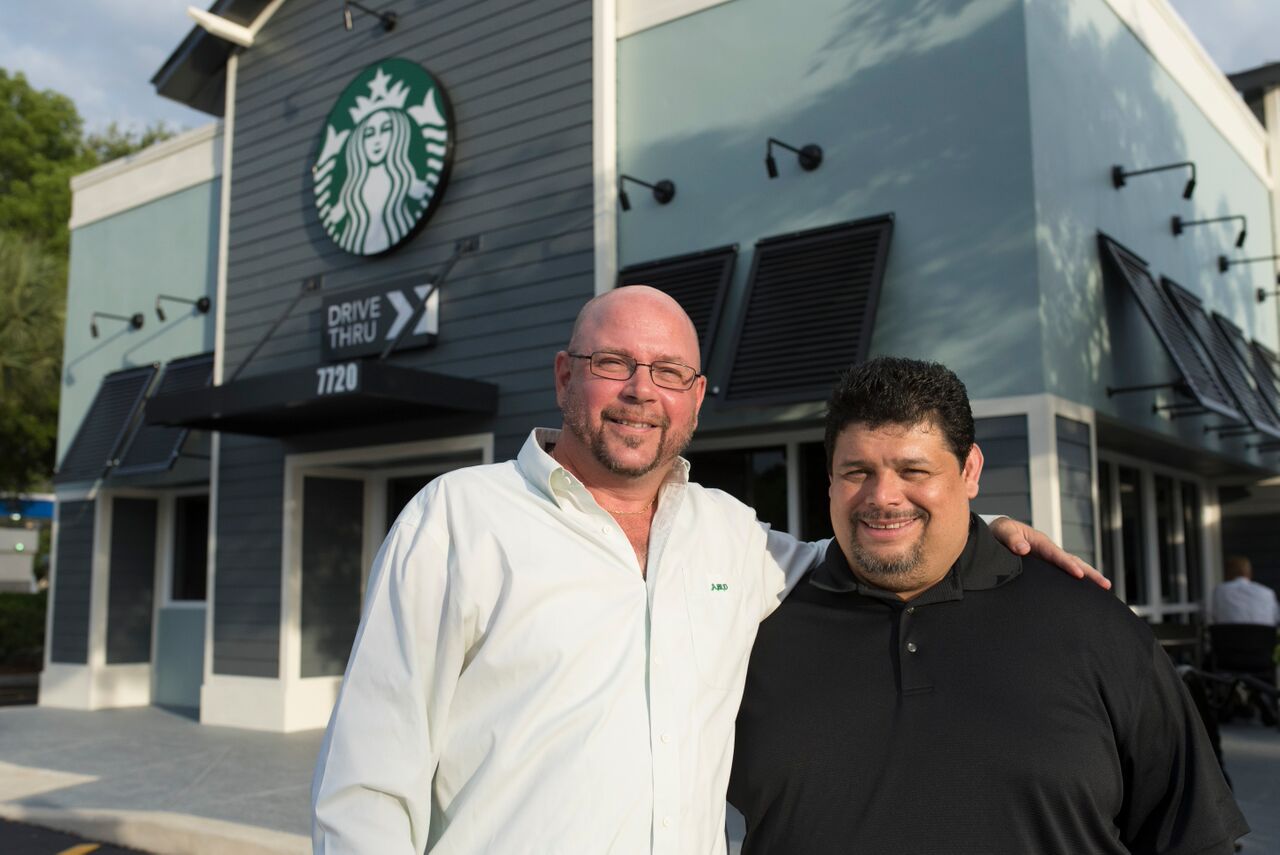 Starbucks District Manager Artie Dohler and Store Manager Eddy Salazar.  - Photos by Adam Baron