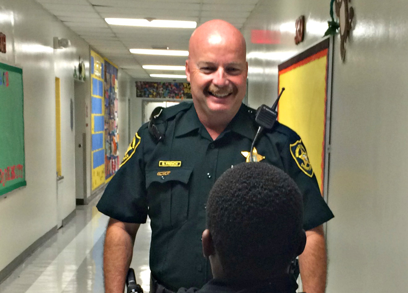 SRO Officer Barry French speaks to a student. French is busy splitting his time between two schools: Tamarac Elementary and Challenger Elementary.