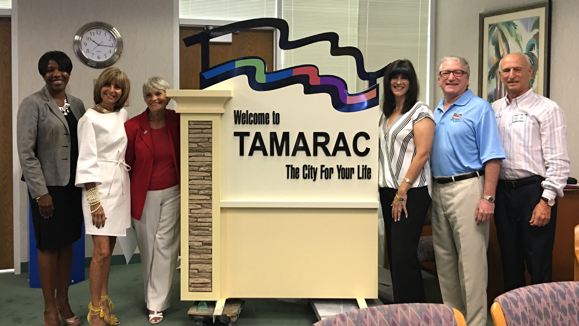 New signage was unveiled at the commission workshop on Monday. L to R: Community Development Director Maxine Calloway, Commissioners Debra Placko, Pamela Bushnell, Michelle Gomez, Mayor Harry Dressler and Baron Sign Manufacturing President Jerry Foland