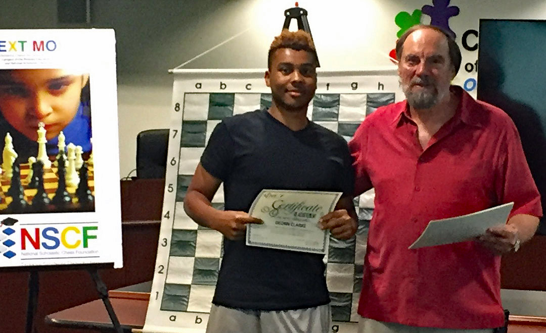 Senior Instructor Bill Cornwall, of Coral Springs, presents a certificate to Deonn Clarke at a NSCF teacher training event conducted with the Children’s Services Council earlier this year. 