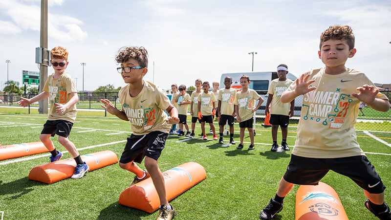 Forget the Heat; Dolphins Football Camp Moves Indoors For The Summer